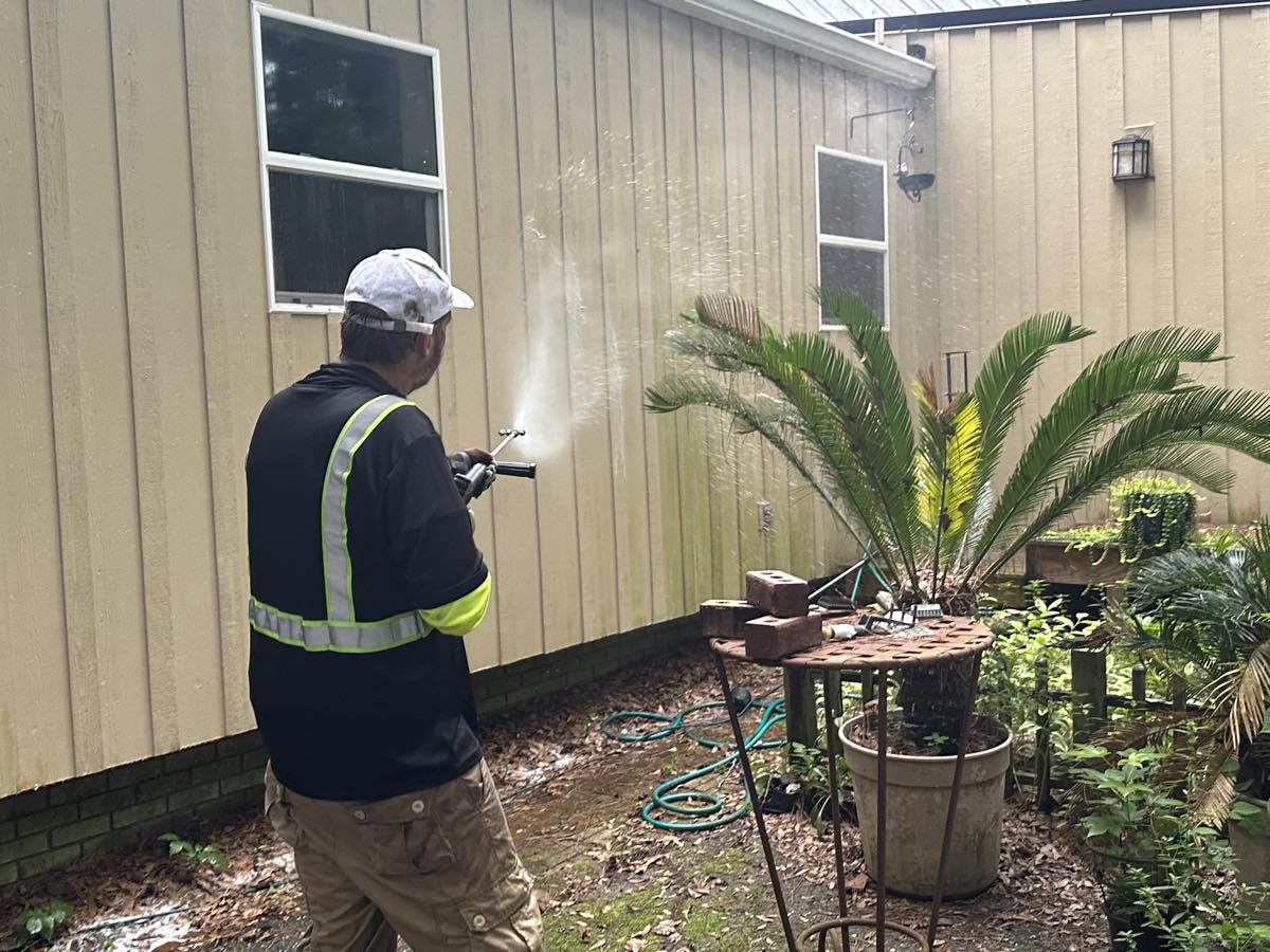 Applying soft wash solution to a home's siding